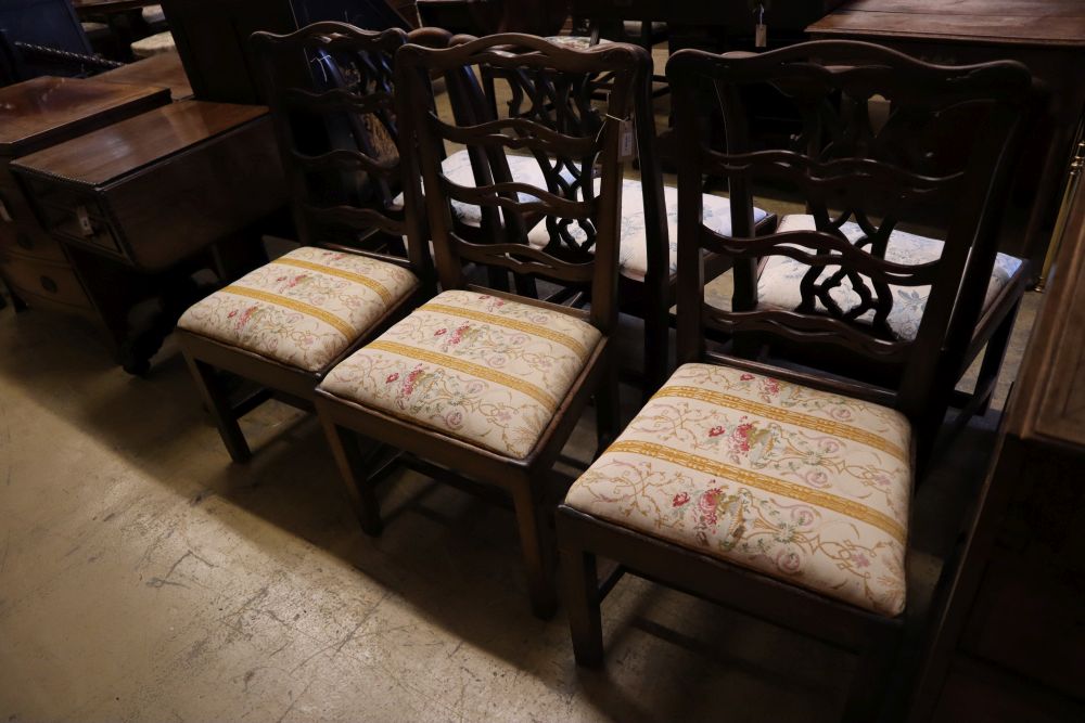 A set of three George III mahogany dining chairs with crewel-work seats and another set of three George III dining chairs (6)